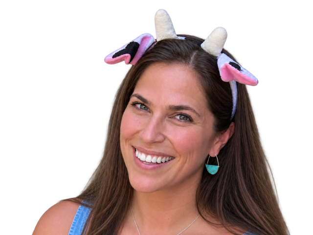 Smiling woman wearing cow ears headband, turquoise earrings and necklace