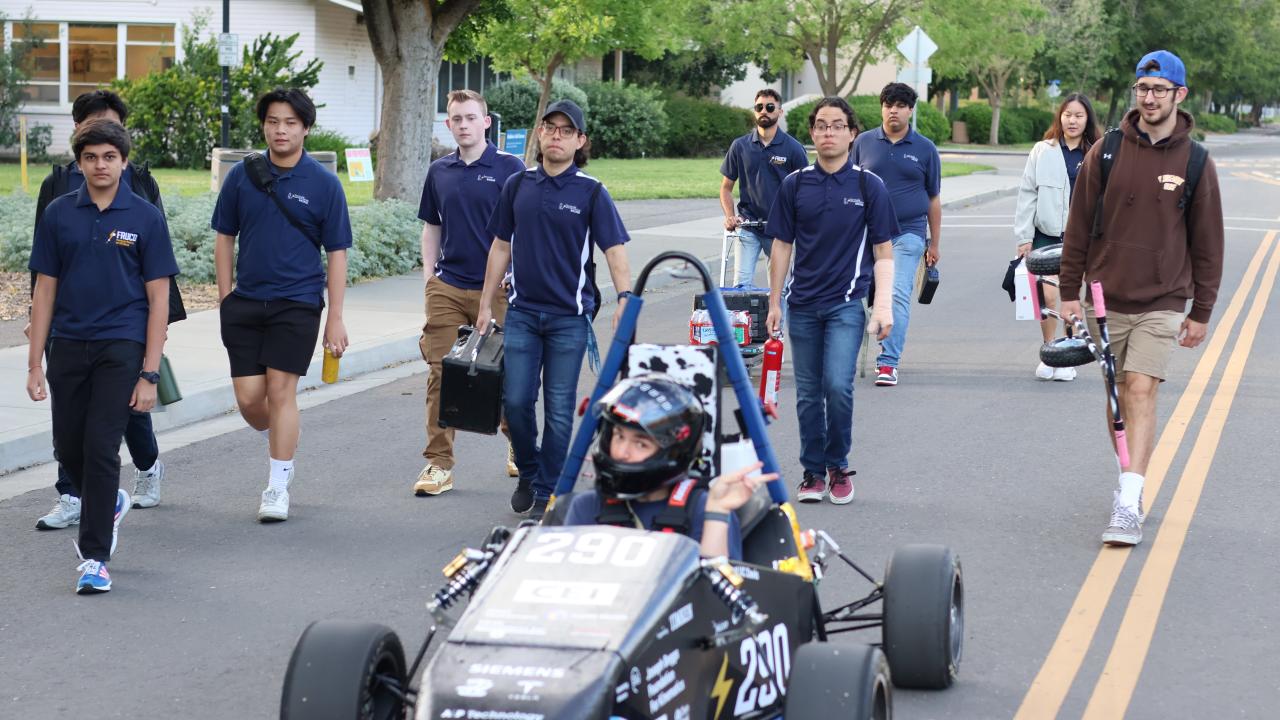 Students from project Green Speed with their electric racecar.