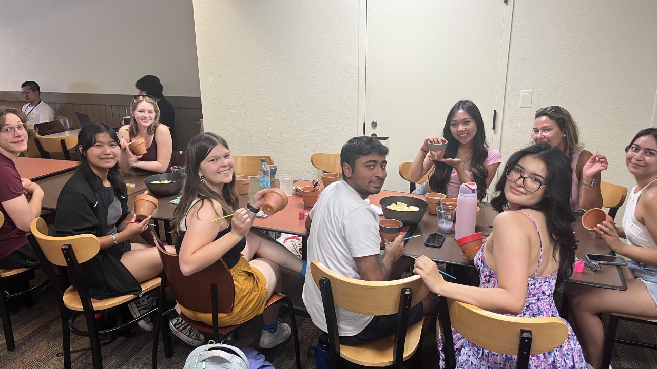 Image of Sprout Up's college teachers painting pots as part of a club social event.