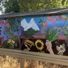 Image of part of the completed mural. Contains various depictions of plants, insects, and birds.